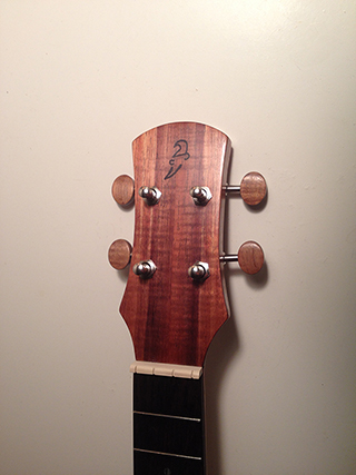 Treble-Rose ukulele made in Koa with spruce top and rosewood highlights, close up of headstock